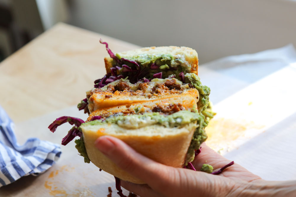 hand holding stacked chorizo torta