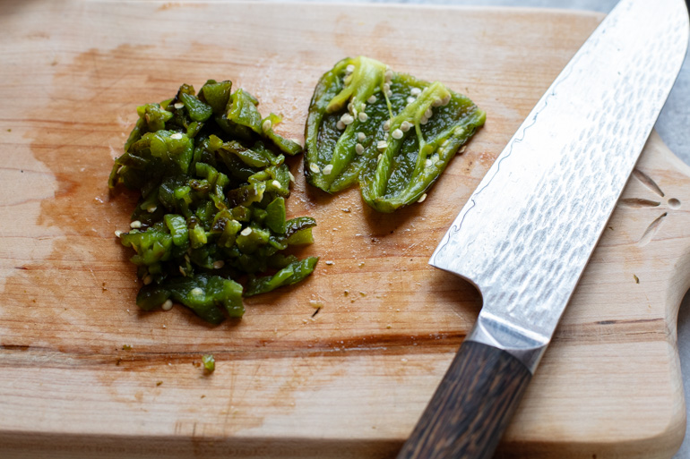 cutting board and knife with diced roasted jalape&ntilde;o 