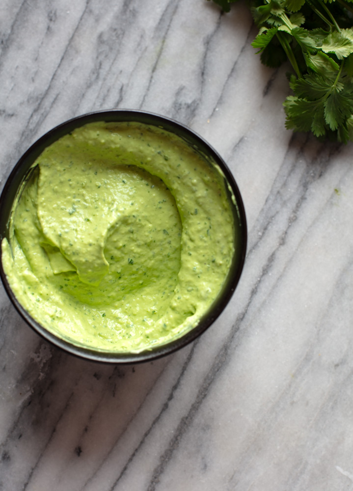 black bowl with avocado crema