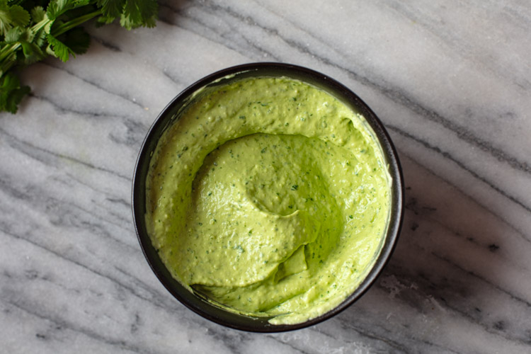 avocado crema in small black bowl