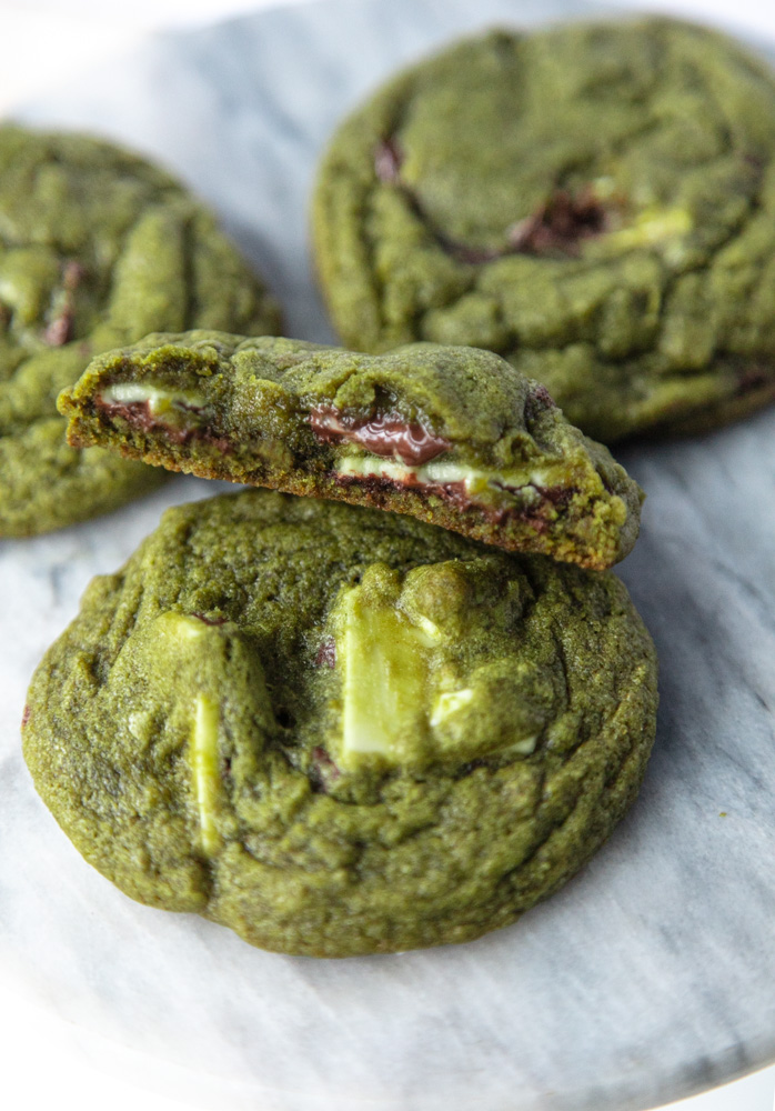 matcha cookies with one cookie half showing melty chocolate center