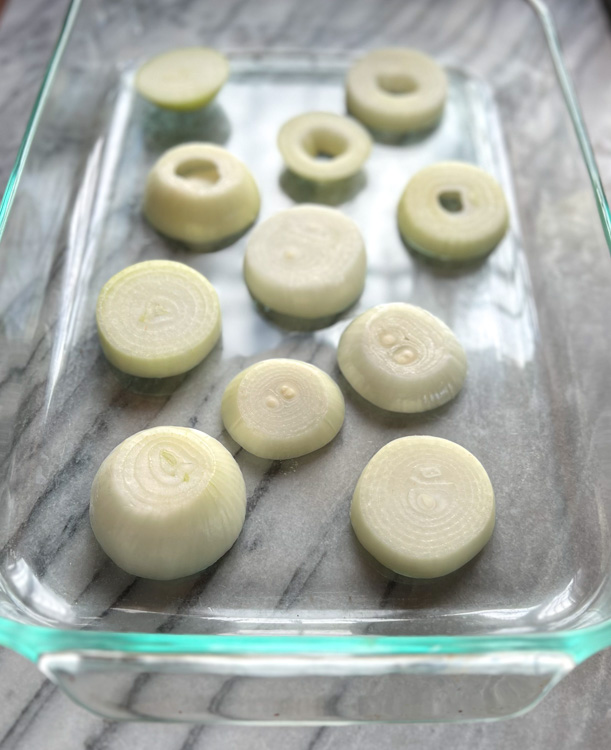sliced onions in glass baking dish