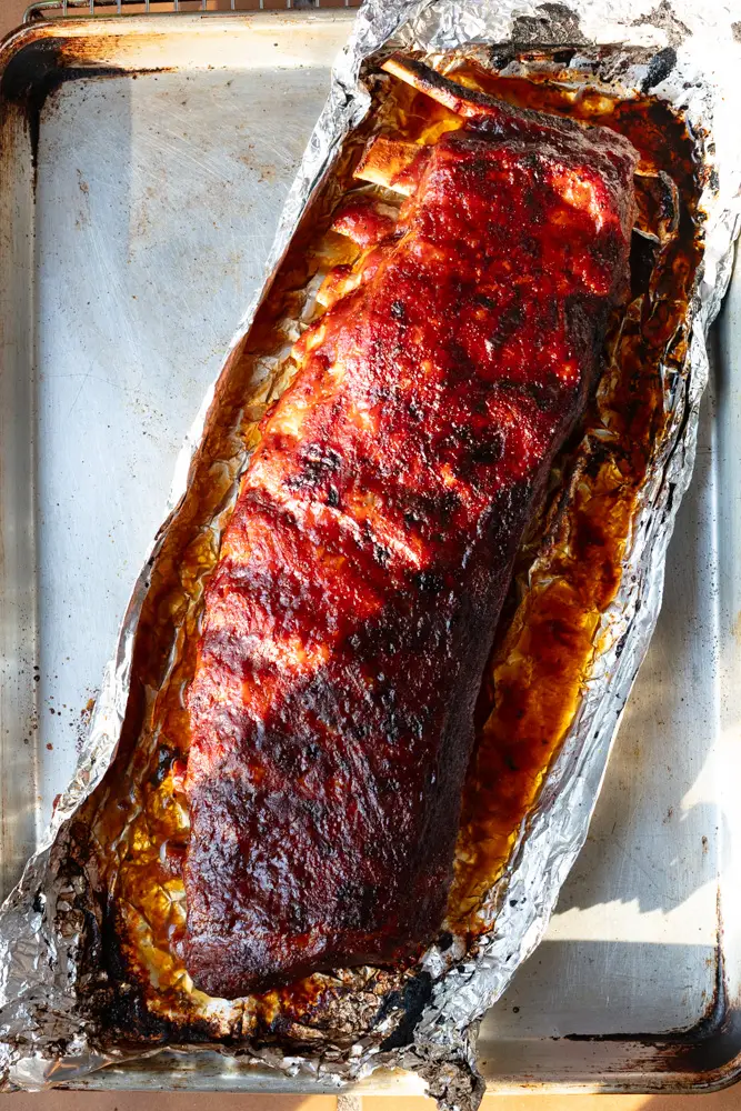 rack of st louis style bbq ribs on sheet pan