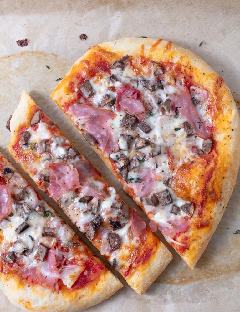 small Pizza with ham and mushrooms cut into thirds