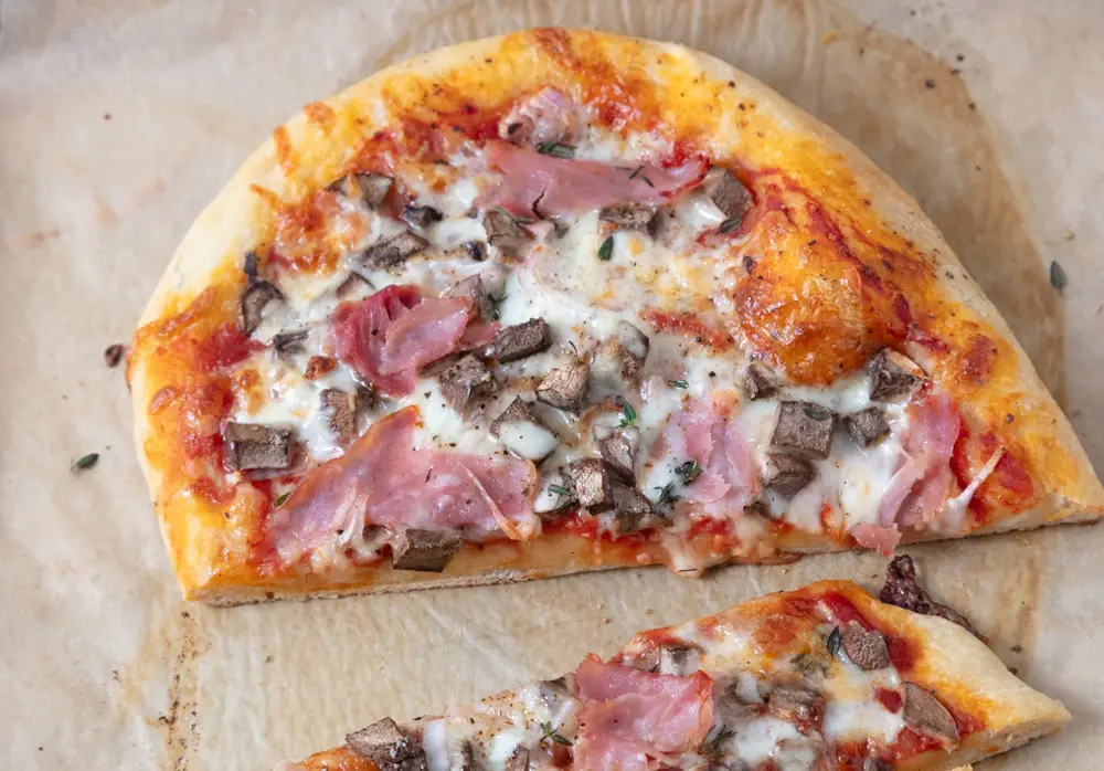 ham and cheese and mushroom pizza sliced
