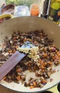 garlic over sauteed vegetables in pan