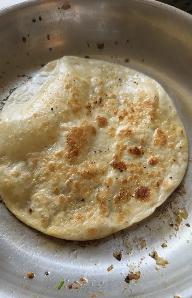 tortilla cooking in skillet