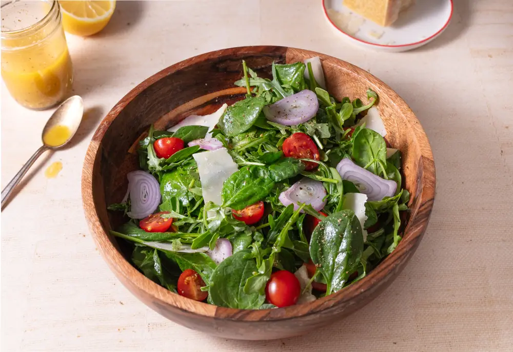 Spinach arugula salad in a wooden salad bowl.