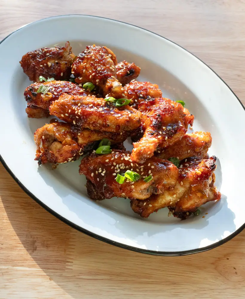 Crispy soy garlic chicken wings on a serving platter.