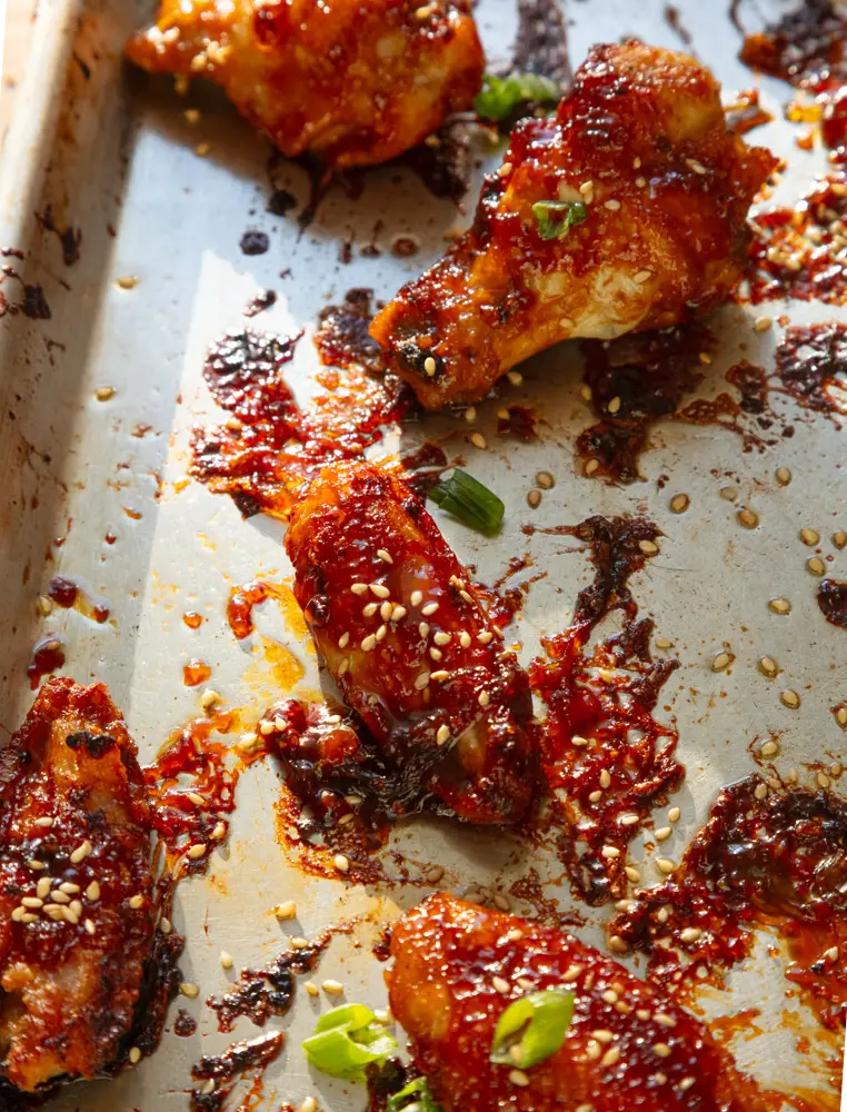 Overhead shot of soy garlic chicken wings on a sheet pan.