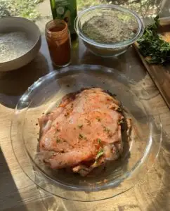 Thin pieces of chicken coated in seasoning in a bowl.