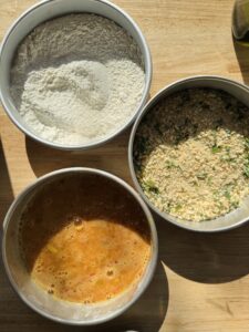 Overhead shot of the breading ingredients in shallow bowls.