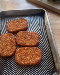crispy golden hash browns on baking sheet used as base for egg salad toast or easy brunch recipe