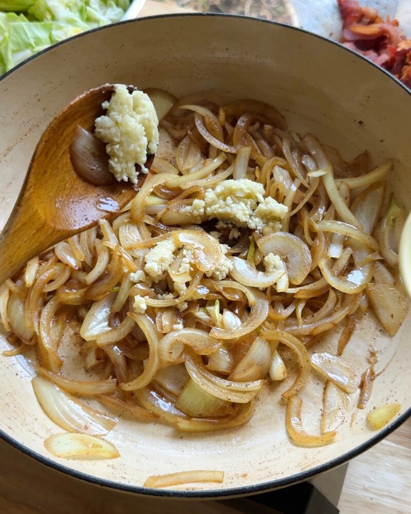 minced garlic added to saut&eacute;ed onions in skillet for sauteed cabbage recipe