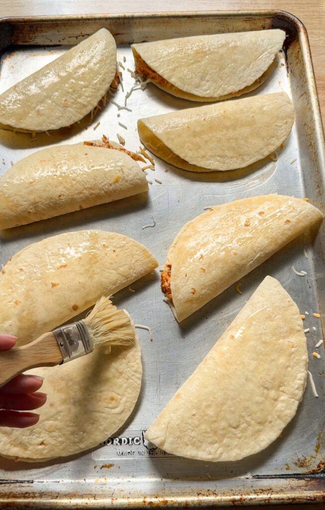 brushing tortillas with oil before baking to make crispy chicken tacos