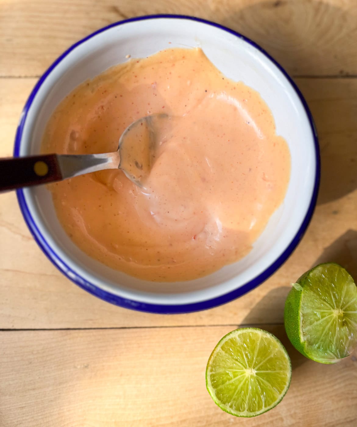 bang bang sauce in a bowl with lime creamy sweet and spicy sauce