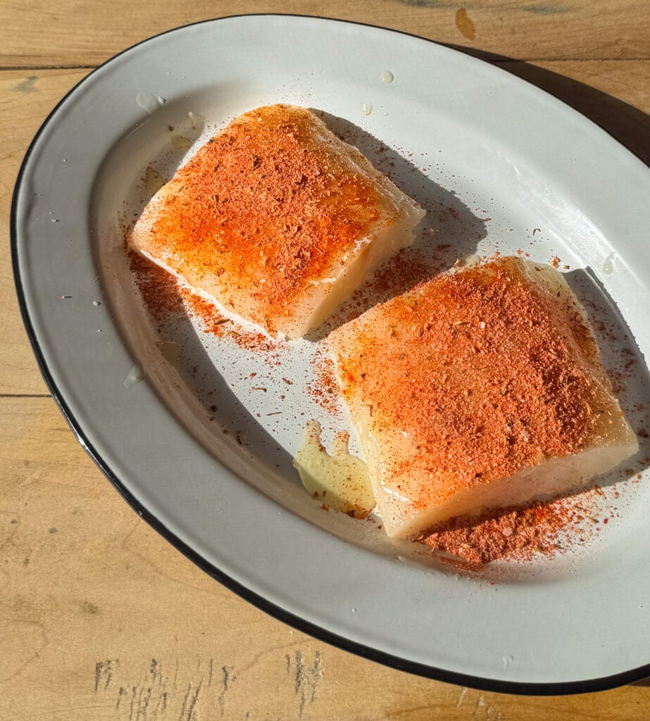 blackened seasoning on cod fillets before cooking