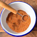 homemade chicken taco seasoning in a bowl with measuring spoon showing spice texture