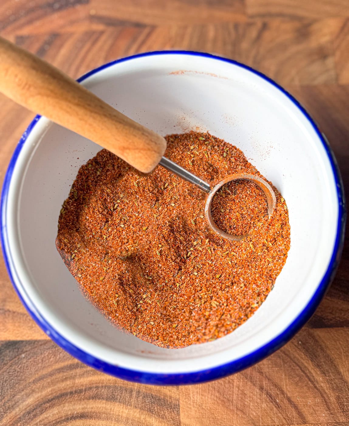 homemade chicken taco seasoning in a bowl with measuring spoon showing spice texture