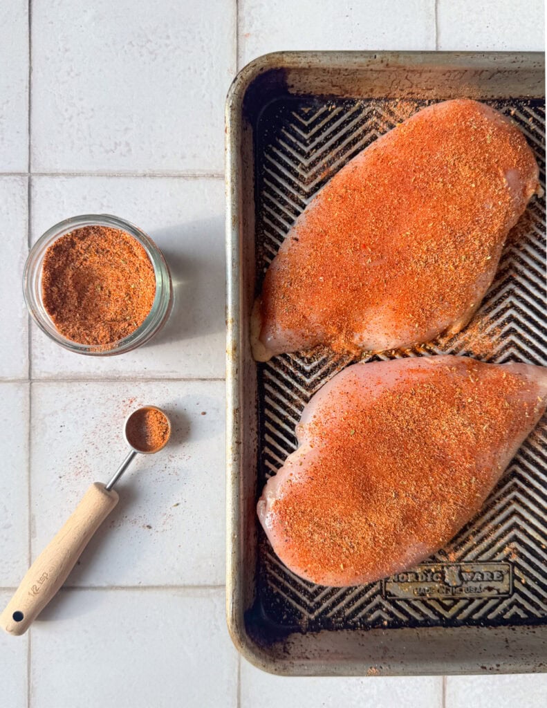 chicken breasts seasoned with homemade taco seasoning on a sheet pan