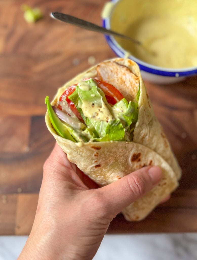 grilled chicken wrap with honey mustard sauce and fresh vegetables in tortilla
