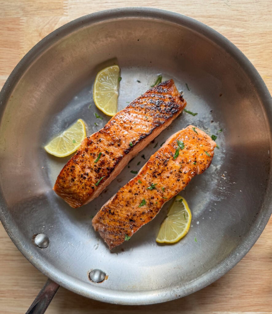 seared salmon fillets in a pan