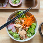 salmon rice bowl with spicy mayo avocado cucumber and edamame