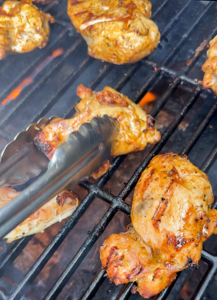 grilled chicken thighs cooking on a grill