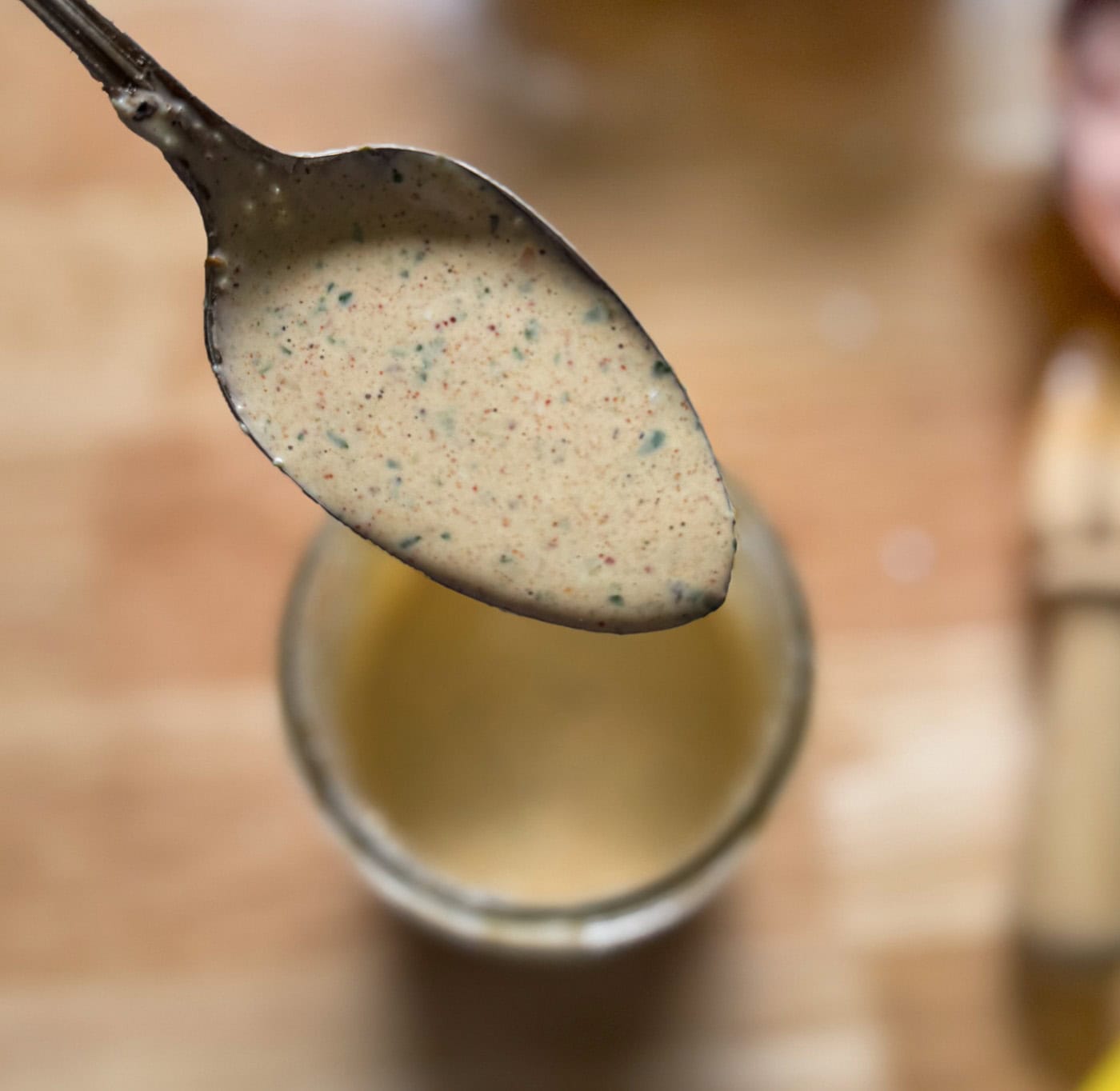 creamy taco salad dressing on a spoon showing texture and consistency