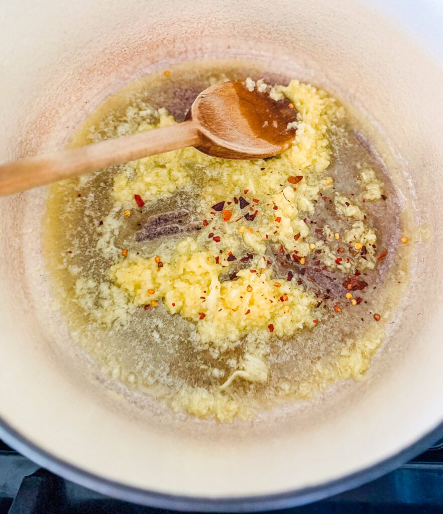 This is the step that makes alfredo so good &mdash; real parmesan melting into a creamy garlic butter sauce.